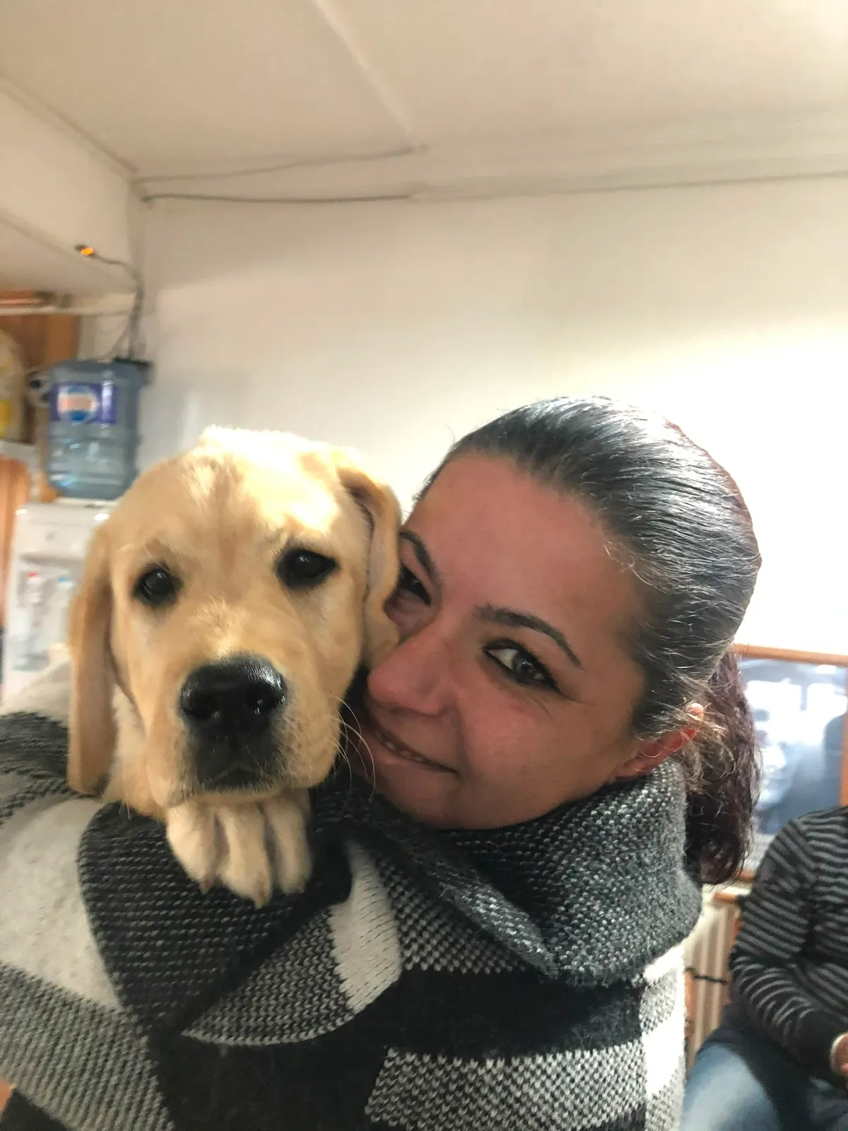 A golden retriever cheek to cheek with their owner